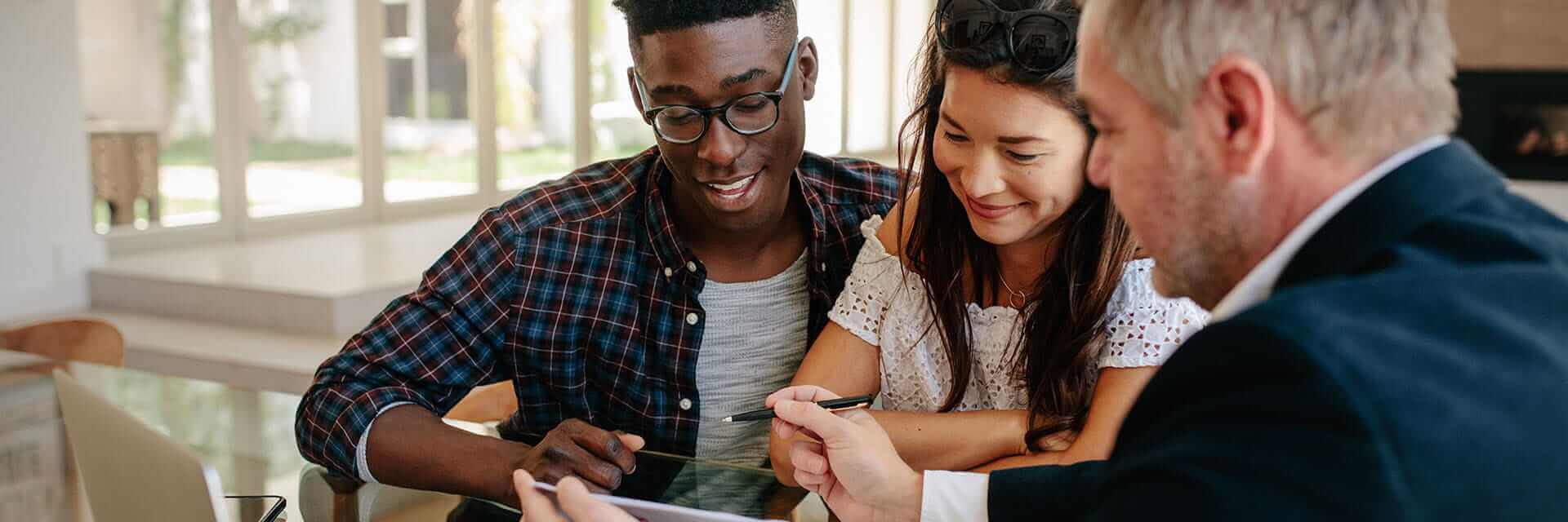 A young couple working with their financial professional to plan for their future.