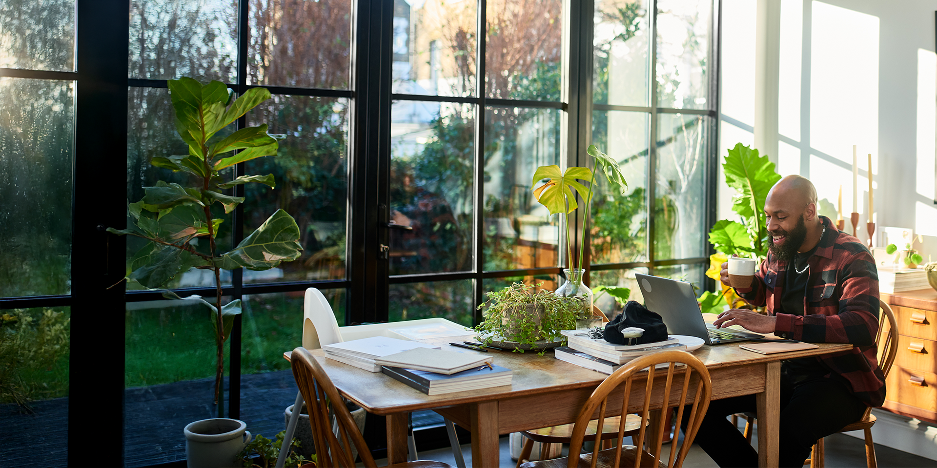 Male intern smiling while using laptop